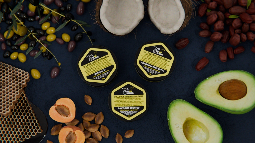 product render of a body butter tub surrounded by fruit olives and honey