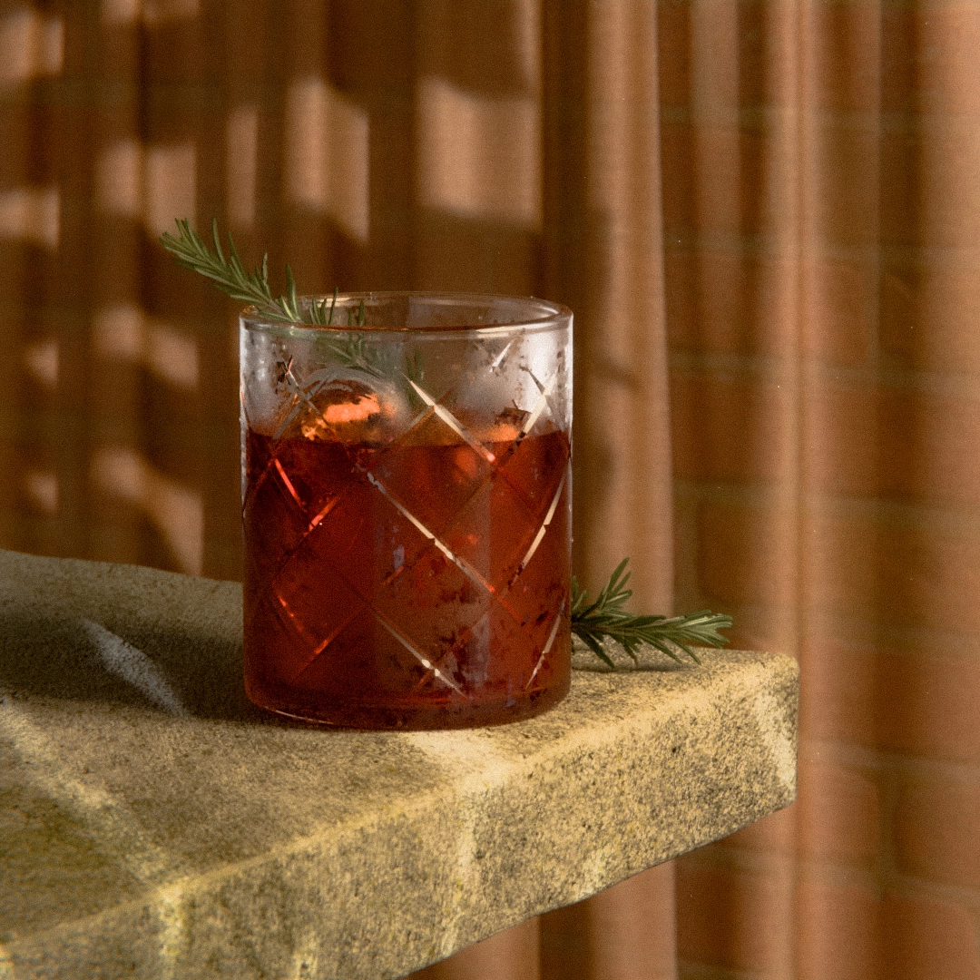 product render of a negroni cocktail on a table